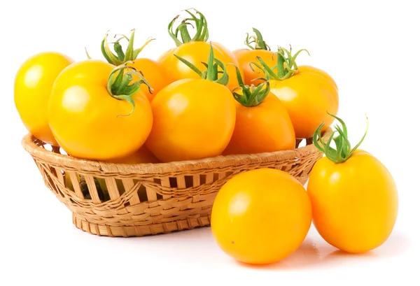 Yellow tomatoes in a wicker basket isolated on white background — Stock Photo, Image