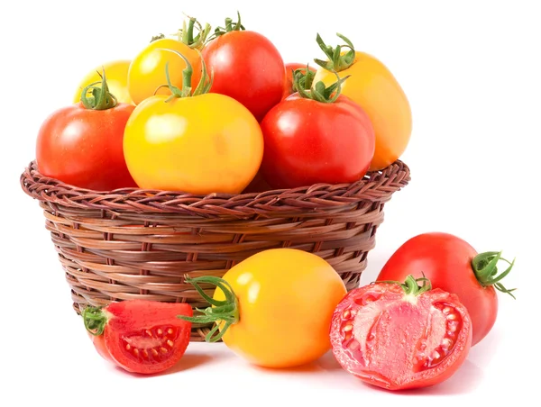 Red and yellow tomatoes in a wicker basket isolated on white background — Stock Photo, Image