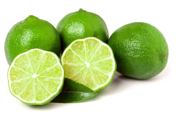 Three limes with halves and leaf isolated on white background — Stock Photo, Image