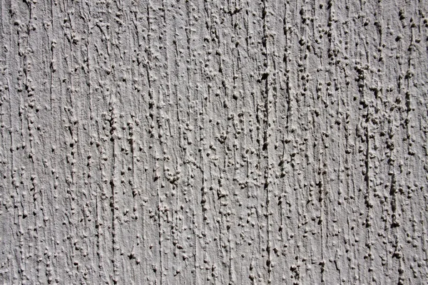 Grey wall with decorative plaster as a background — Stock Photo, Image