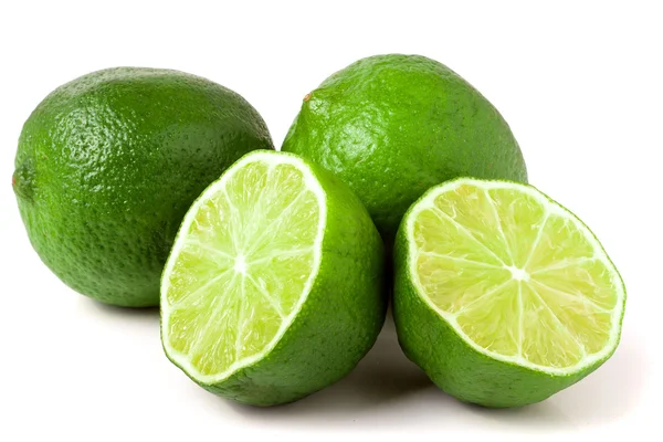 Two limes with halves isolated on white background — Stock Photo, Image