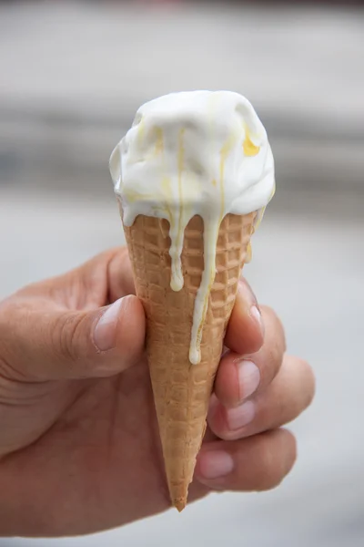 white ice cream cone with wafer in the hand