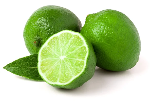 Two limes with half and leaf isolated on white background — Stock Photo, Image