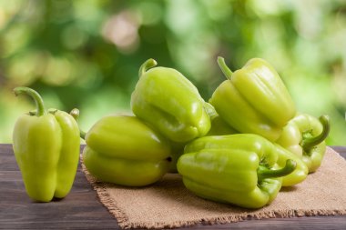 arka plan bulanık bir tahta masada yeşil biber kazık