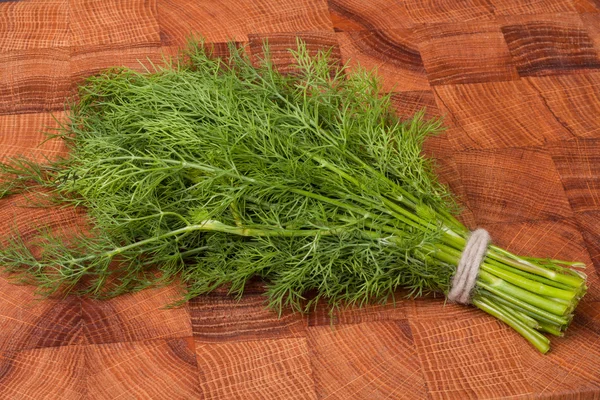 Bunch of dill on wooden background — Stock Photo, Image