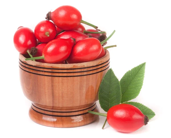 Rosehip berries in a wooden bowl isolated on white background — Stock Photo, Image