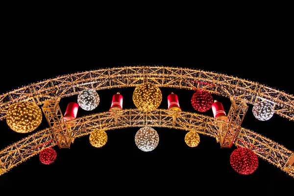 Christmas time night street fair decoration arch with colorful lights and toys night street outdoor scenic foreshortening from below