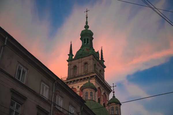 architecture building landmark touristic photography of tower in Lviv Ukraine Eastern Europe city foreshortening from below in evening sunset time with purple and blue sky background scenery view