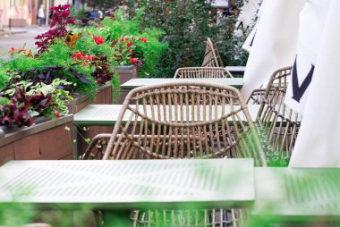 cafe patio external outdoor space of furniture table and chairs with blossom spring day flower pots decorative objects without people here