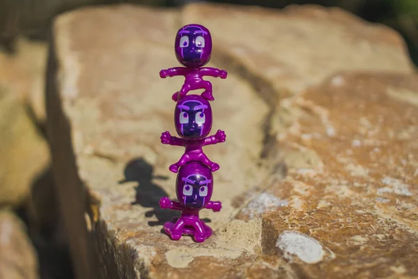 violet ninja figurines standing on each other