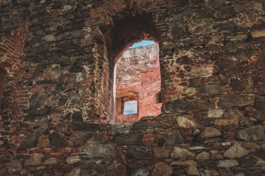 windows in the old stone wall of the historical building in Poland