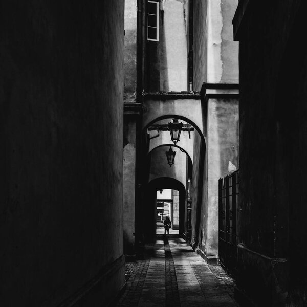 Silhouette in the alley, street photography, monochrome, Warsaw, Poland