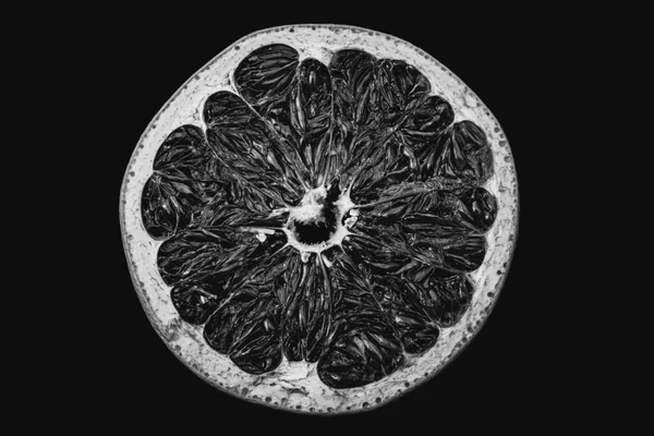 grapefruit cut in half, still life, studio photography, fruit on a black background