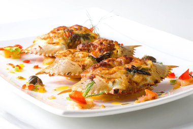 Yengeç konisi, deniz ürünleri tatmadan önce beyaz bir tabakta ana giriş..