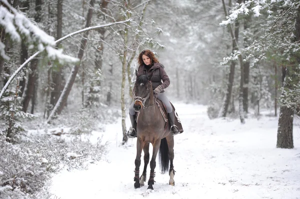 young woman riding in the snow