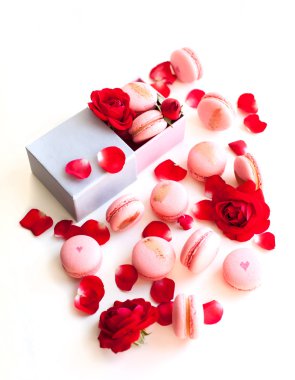 Pink macaron in a gift box with rose petals