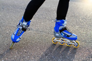 girl riding rollers at sunset