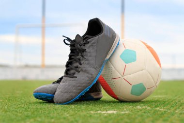 soccer boots resting on the ball