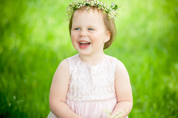 funny baby girl smiling outdoors
