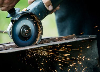 Metal bir plaka üzerinde bir değirmeni kullanarak alt closeup