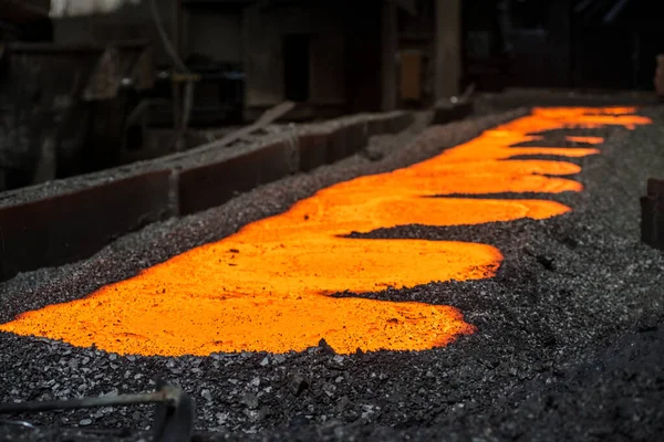 liquid metal in the molds at the steel mill closeup