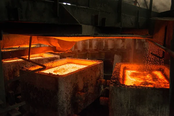 liquid metal in the molds by carousel machine at the steel mill