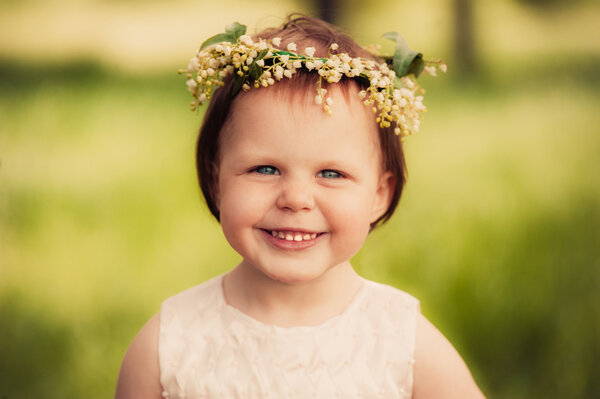 Little girl in wreath of flowers