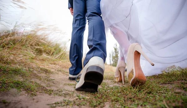 Ноги нареченим і нареченим, молодята ходять на відкритому повітрі — стокове фото