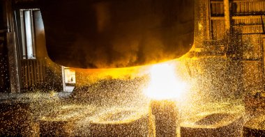 İşçi sıvı metal kalıpları tankından içine dökülen