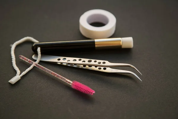 Equipment for eyelash extensions on a dark background — Stock Photo, Image