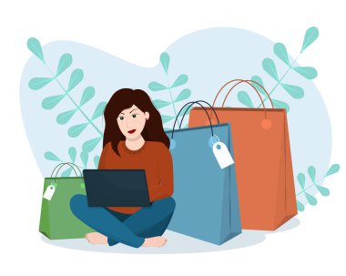  Genç bir esmer kadın dizüstü bilgisayarıyla oturup online alışveriş yapıyor.