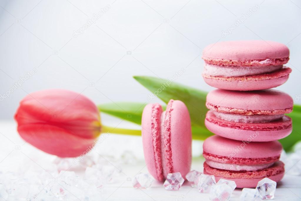 Sweet pink macaroons on wooden table