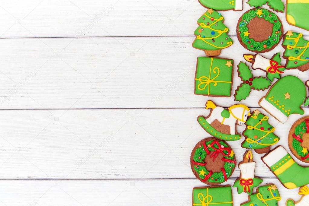 Christmas green gingerbread cookies on wooden background
