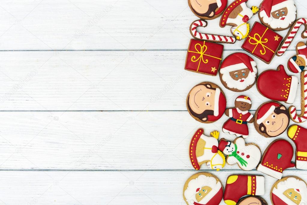Christmas red gingerbread cookies on wooden background