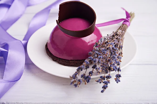 Mini cake with black currant and creamy mousse.