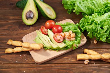 Vegetables and shrimps on a wooden background