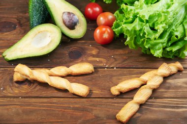 Vegetables and shrimps on a wooden background