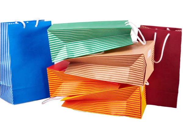 Πολύχρωμο τσάντες αγορών σε χαρτί που απομονώνονται σε λευκό — Φωτογραφία Αρχείου