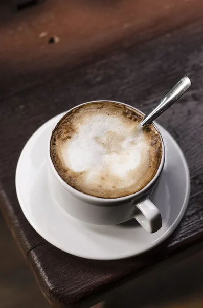 A cup of cappuccino in nature — Stock Photo, Image