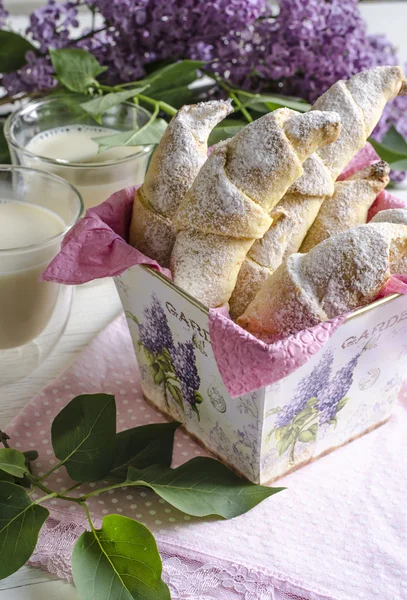 Croissants with milk and lilac — Stock Photo, Image