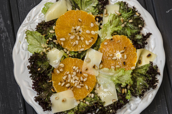 Salad with orange pine nuts and Parmesan