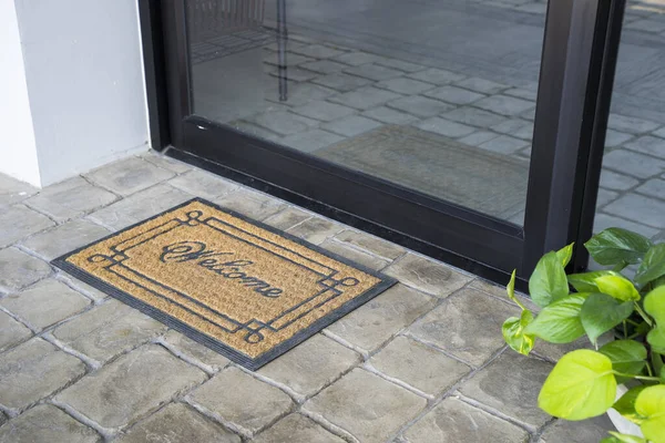 View of welcome mat outside inviting in front of door house