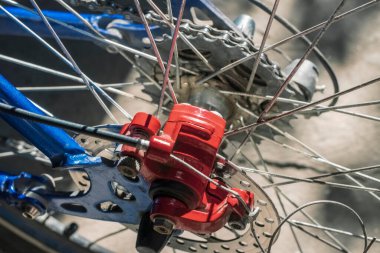 Red brake drum of rear wheel on blue bike close up
