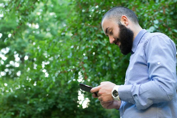 Hombre barbudo guapo con teléfono inteligente —  Fotos de Stock