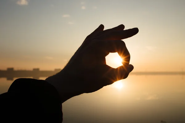 Hand silhouette holding sun — Stock Photo, Image