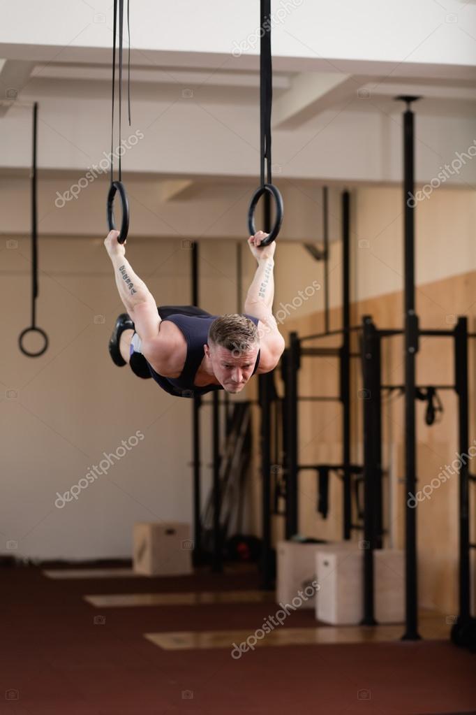 Gymnastic ring hanging in gym on blurred background stock photo