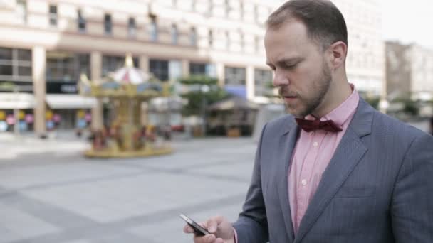 Dospělé podnikatel hovoří na mobilním telefonu v město avenue — Stock video