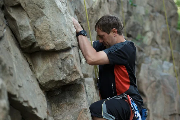 Masculino alpinista apega-se a um penhasco — Fotografia de Stock