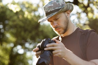Erkek turist görünümlü fotoğraflar açık havada onun Dslr kameraya yakalanan