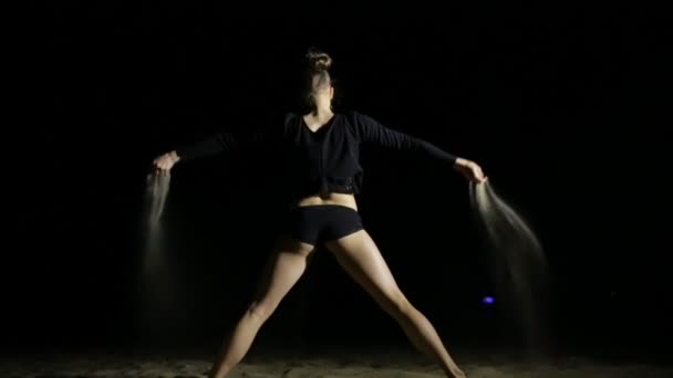 Sexy woman pouring sand at night beach — Stock Video